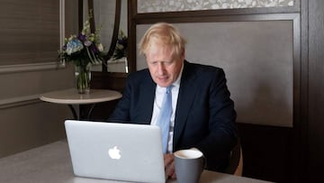 Britain&#039;s Prime Minister Boris Johnson poses for a photograph as he prepares his speech on a laptop in his hotel room, on the third day of the annual Conservative Party Conference in Manchester, northwest England, on October 5, 2021, ahead of his key