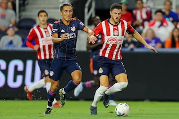 Sep 21, 2022; Cincinnati, OH, USA; FC Cincinnati forward Yuya Kubo (7) battles for the ball against Club Deportivo Guadalajara defender Hiram Mier (21) in the first half at TQL Stadium. Mandatory Credit: Katie Stratman-USA TODAY Sports