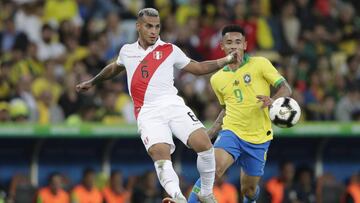 Peru&#039;s Miguel Angel Trauco, left, fights for the ball with Brazil&#039;s Gabriel Jesus during the final match of the Copa America at Maracana stadium in Rio de Janeiro, Brazil, Sunday, July 7, 2019. (AP Photo/Silvia Izquierdo)