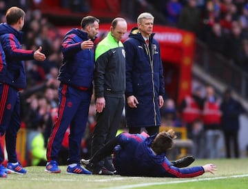 Manchester United boss Louis van Gaal (bottom) gestures to fourth official Mike Dean (C) as Arsenal manager Arsene Wenger (R) looks on during the sides' Premier League clash at Old Trafford.