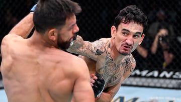 LAS VEGAS, NEVADA - NOVEMBER 13: (R-L) Max Holloway punches Yair Rodriguez of Mexico in a featherweight fight during the UFC Fight Night event at UFC APEX on November 13, 2021 in Las Vegas, Nevada. (Photo by Chris Unger/Zuffa LLC)