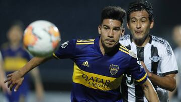 Guillermo Fernandez of Argentina's Boca Juniors, left, and Luis Cardozo of Paraguay's Libertad battle for the ball during a Copa Libertadores soccer match in Asuncion, Paraguay, Thursday, Sept. 17, 2020.(AP Photo/Jorge Saenz, Pool)