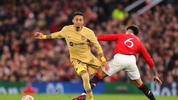 MANCHESTER, ENGLAND - FEBRUARY 23: Raphinha of Barcelona is tackled by Lisandro Martinez of Manchester United during the UEFA Europa League knockout round play-off leg two match between Manchester United and FC Barcelona at Old Trafford on February 23, 2023 in Manchester, England. (Photo by James Gill - Danehouse/Getty Images)