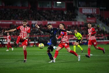 Yannick Carrasco se prepara para lanzar a la portería de Paulo Gazzaniga entre los jugadores del Girona, Santiago Bueno y Borja García.