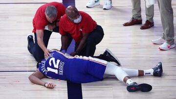 Aug 23, 2020; Lake Buena Vista, Florida, USA; Philadelphia 76ers forward Tobias Harris (12) is attended to after hitting his head against the Boston Celtics during the third quarter in game four of an NBA basketball first-round playoff series at The Field House. Mandatory Credit: Kim Klement-USA TODAY Sports