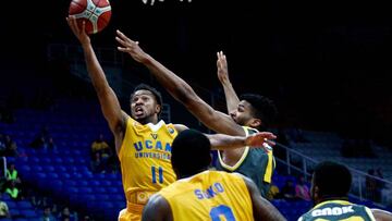 Riesen Ludwigsburg's Adika Peter McNeilly (R) vies with UCAM Murcia's Clevin Hannah (L) during the final four Champions League basketball 3rd place game between Riesen Ludwigsburg and Ucam Murcia at the OAKA stadium, in Athens on April 6, 2018.