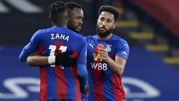 Crystal Palace's Jordan Ayew celebrates with Wilfried Zaha, left, and Andros Townsend, right, after scoring his side's fourth goal during the English Premier League soccer match between Crystal Palace and Leeds United at the Selhurst Park stadiu