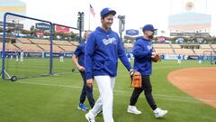 Mar 25, 2024; Los Angeles, California, USA; Los Angeles Dodgers designated hitter Shohei Ohtani (center) walks with athletic trainer Thomas Albert (left) and vice president of player performance Brandon McDaniel before the game against the Los Angeles Angels at Dodger Stadium. Mandatory Credit: Kirby Lee-USA TODAY Sports