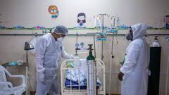 Health personnel care for a child infected with COVID-19 at the Intensive Care ward of the Felipe Urriola Hospital in Iquitos, Peru on July 8, 2020. - Among the patients with COVID-19 in Peru are 24 children in the hospital in Iquitos, the largest city in the Peruvian Amazon, which was the first region in the country to feel the rigours of the pandemic. (Photo by Cesar Von BANCELS / AFP)