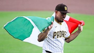 Sep 27, 2025; San Diego, California, USA; San Diego Padres relief pitcher Jeremiah Estrada (56) walks off the field draped in a Mexican flag after a ceremony held for Hispanic Heritage Weekend at Petco Park. Mandatory Credit: Denis Poroy-Imagn Images