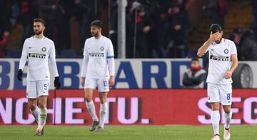 Inter Milan's Roberto Gagliardini and Antonio Candreva look dejected after Andrea Ranocchia (C) scored an own goal and the first goal for Genoa