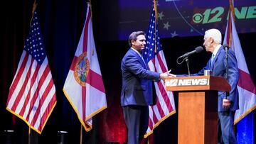 Florida's Republican incumbent Gov. Ron DeSantis shakes hands with his Democratic Party challenger Charlie Crist, a former governor, at the Sunrise Theatre in Fort Pierce, Florida, U.S. October 24, 2022. Crystal Vander Weiter/Pool via REUTERS