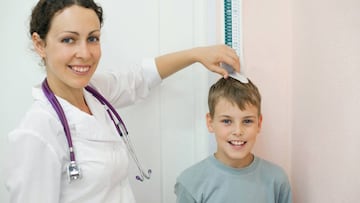 Una doctora mide la estatura de un ni&ntilde;o