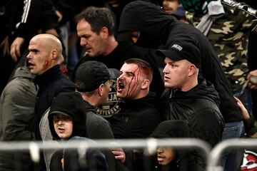 AEK Athens fans jumped onto the pitch and launched flares at the Ajax fans in the Champions League game in Greece on Tuesday night, causing police to intervene.