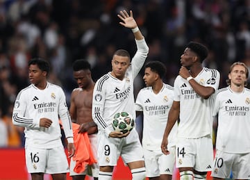 Soccer Football - Champions League - Knockout Phase Playoff - Second Leg - Real Madrid v Manchester City - Santiago Bernabeu, Madrid, Spain - February 19, 2025 Real Madrid's Kylian Mbappe celebrates with Aurelien Tchouameni after the match while holding the match ball after scoring a hat-trick REUTERS/Violeta Santos Moura