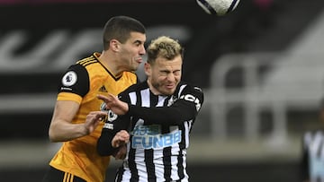 Wolverhampton Wanderers' Conor Coady, left, jumps for a header with Newcastle's Ryan Fraser during the English Premier League soccer match between Newcastle United and Wolves at the St James' Park stadium in Newcastle, England, Sunday, Feb.