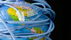 Network cable wrapped around a globe depicting a connected world