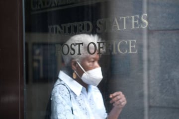 A woman walks into a Brooklyn Post Office on August 05, 2020 in New York City. The United States Postal Service (USPS).