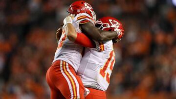 DENVER, CO - OCTOBER 1: Running back Kareem Hunt #27 and quarterback Patrick Mahomes #15 of the Kansas City Chiefs embrace to celebrate a fourth quarter go-ahead touchdown against the Denver Broncos at Broncos Stadium at Mile High on October 1, 2018 in De