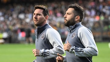 Inter Miami's Argentine forward Lionel Messi (L) and Spanish defender Jordi Alba run during training for the friendly football match between Hong Kong Team and US Inter Miami CF at the Hong Kong Stadium in Hong Kong on February 3, 2024. (Photo by Peter PARKS / AFP)