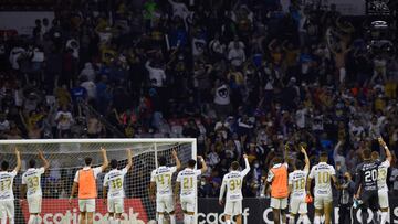 Pumas's players celebrates with their supporters after defeating Cruz Azul during their second leg semi-final CONCACAF Champions League football match at Azteca stadium in Mexico City, April 12, 2022. (Photo by ALFREDO ESTRELLA / AFP)