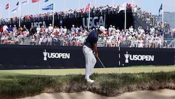 Scottie Scheffler of the United States chips on the ninth green during the final round of the 123rd U.S. Open Championship