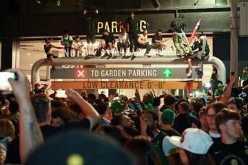 Jun 17, 2024; Boston, Massachusetts, USA; Boston Celtics Fans climb sign posts outside of the TD Garden after after the Boston Celtics defeated the Dallas Mavericks in game five of the 2024 NBA Finals at the TD Garden. Mandatory Credit: Brian Fluharty-USA TODAY Sports