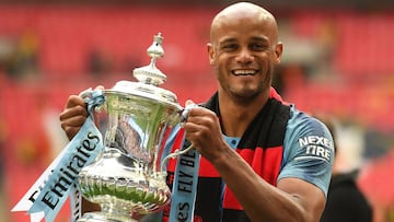 (FILES) In this file photo taken on May 18, 2019 Manchester City's Belgian captain Vincent Kompany holds the winner's trophy after the English FA Cup final football match between Manchester City and Watford at Wembley Stadium in London. - The FA