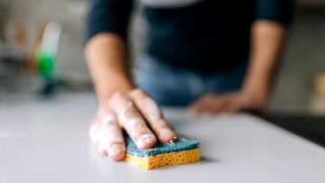 Close up shot of an unrecognisable man cleaning kitchen counter with sponge