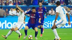 MIAMI GARDENS, FL - JULY 29: Lionel Messi #10 of Barcelona scores against the defense of Raphael Varane #5 and Luka Modric #10 of Real Madrid in the first half during their International Champions Cup 2017 match at Hard Rock Stadium on July 29, 2017 in Miami Gardens, Florida.   Chris Trotman/Getty Images/AFP
 == FOR NEWSPAPERS, INTERNET, TELCOS &amp; TELEVISION USE ONLY ==