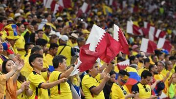 Ecuador supporters wave Qatar national flags ahead of the Qatar 2022 World Cup Group A football match between Qatar and Ecuador at the Al-Bayt Stadium in Al Khor, north of Doha on November 20, 2022. (Photo by Glyn KIRK / AFP) (Photo by GLYN KIRK/AFP via Getty Images)