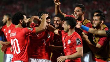 Egypt&#039;s midfielder Mahmoud &#039;Trezeguet&#039; Hassan (2nd-L) celebrates with his teammates after scoring a goal during the 2019 Africa Cup of Nations (CAN) football match between Egypt and Zimbabwe at Cairo International Stadium on June 21, 2019. 