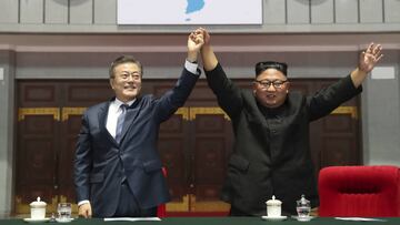 South Korean President Moon Jae-in and North Korean leader Kim Jong Un raise their hands after watching the mass games performance of &quot;The Glorious Country&quot; at May Day Stadium in Pyongyang, North Korea, Wednesday, Sept. 19, 2018. (Pyongyang Pres