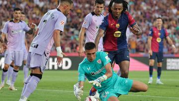 Barcelona's French defender #23 Jules Kounde and Athletic Bilbao's Mexican goalkeeper #26 Alex Padilla (BOTTOM) vie for the ball during the Spanish league football match between FC Barcelona and Athletic Club Bilbao at the Estadi Olimpic Lluis Companys in Barcelona on August 24, 2024. (Photo by LLUIS GENE / AFP)
