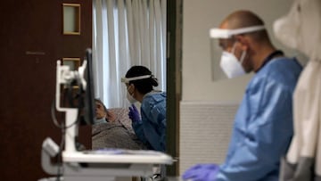 Israeli medical workers tend to patients infected by the coronavirus, in an isolation ward at the Ziv Medical Centre in the northen Israeli city of Safed, on February 6, 2022 