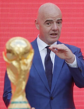 FIFA President Gianni Infantino gestures as he stands behind the trophy at the FIFA World Cup Trophy Tour kick-off ceremony