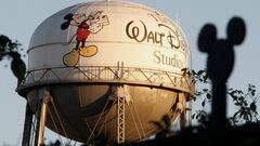 FILE PHOTO: The water tower at The Walt Disney Co., featuring the character Mickey Mouse, is seen behind a silhouette of mouse ears on the fencing surrounding the company's headquarters in Burbank, California, February 7, 2011. REUTERS/Fred Prouser/File Photo