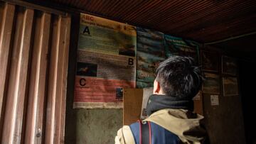 A resident reads a sign about the risks of living near the Nevado del Ruiz volcano in Murillo, Tolima department, Colombia, on Saturday, April 8, 2023. Authorities are urging evacuations as the Colombian Geological Service (SGC) maintains an orange alert for a high probability of eruption of the Nevado del Ruiz volcano in the coming days or weeks, which could affect 19 municipalities in the departments of Tolima, Caldas and Risaralda. Photographer: Jar F. Coll / Bloomberg