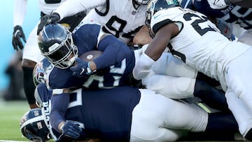 Derrick Henry, #22 of the Tennessee Titans, carries the ball during the second half against the Jacksonville Jaguars.