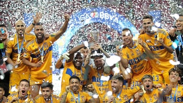 Tigres' Brazilian defender Samir de Souza (C, left) and Uruguayan forward Nicolas Lopez (C, right) raise the trophy after winning the Mexican Clausura football tournament by defeating Guadalajara 3-2 in extra-time of the second leg final match at Akron Stadium in Zapopan, Jalisco State, Mexico, on May 28, 2023. (Photo by ULISES RUIZ / AFP)