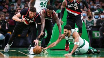 Jan 21, 2022; Boston, Massachusetts, USA; Boston Celtics forward Jayson Tatum (0) dives for a loose ball against Portland Trail Blazers center Jusuf Nurkic (27) and forward Nassir Little (9) during the first half at TD Garden. Mandatory Credit: Paul Rutherford-USA TODAY Sports