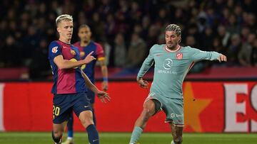 Atletico Madrid's Argentine midfielder #05 Rodrigo De Paul (R) is challenged by Barcelona's Spanish forward #20 Daniel Olmo during the Spanish league football match between FC Barcelona and Club Atletico de Madrid at the Estadi Olimpic Lluis Companys in Barcelona on December 21, 2024. (Photo by MANAURE QUINTERO / AFP)