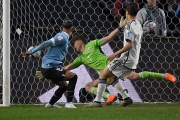 Uruguay's forward Luciano Rodriguez (L) heads the ball to score a goal during the Argentina 2023 U-20 World Cup final match between Uruguay and Italy at the Estadio Unico Diego Armando Maradona stadium in La Plata, Argentina, on June 11, 2023. (Photo by Luis ROBAYO / AFP)