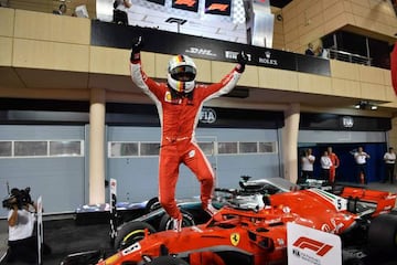 Ferrari's German driver Sebastian Vettel jumps out of his car after winning the Bahrain Formula One Grand Prix at the Sakhir circuit in Manama on April 8, 2018.