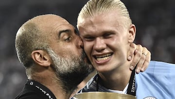 Manchester City's Spanish manager Pep Guardiola (L) kisses Manchester City's Norwegian striker #09 Erling Haaland after winning the 2023 UEFA Super Cup football match between Manchester City and Sevilla at the Georgios Karaiskakis Stadium in Piraeus on August 16, 2023. (Photo by Spyros BAKALIS / AFP)