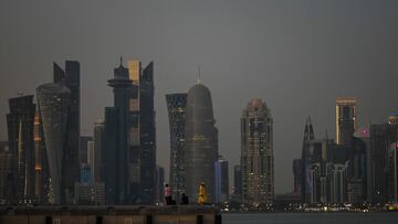 People stand at the Corniche Waterfront in Doha on November 16, 2022, ahead of the Qatar 2022 World Cup football tournament. (Photo by PATRICIA DE MELO MOREIRA / AFP)