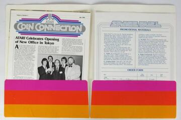 Carpeta con un n迆mero de Coin Connection y materiales promocionales de Space Duel.