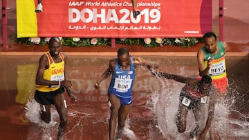 (L-R) Uganda's Benjamin Kiplagat, USA's Hillary Bor and Kenya's Conseslus Kipruto compete in the Men's 3000m steeple chase race heats at the 2019 IAAF Athletics World Championships at the Khalifa International stadium in Doha on October 1, 2019. (Photo by Antonin THUILLIER / AFP)