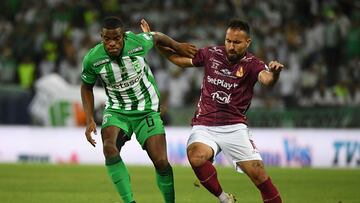 Nacional's defender #06 Andres Roman and Tolima's midfielder #15 Juan Nieto fight for the ball during the Colombian League second leg football final match between Atletico Nacional and Deportes Tolima at the Atanasio Girardot Stadium in Medellin, Colombia on December 22, 2024. (Photo by Jaime SALDARRIAGA / AFP)