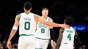 NEW YORK, NEW YORK - FEBRUARY 24: Kristaps Porzingis #8 of the Boston Celtics is congratulated by Jrue Holiday #4 and Jayson Tatum #0 after scoring a basket against the New York Knicks during the second half at Madison Square Garden on February 24, 2024 in New York City. NOTE TO USER: User expressly acknowledges and agrees that, by downloading and or using this photograph, User is consenting to the terms and conditions of the Getty Images License Agreement.   Steven Ryan/Getty Images/AFP (Photo by Steven Ryan / GETTY IMAGES NORTH AMERICA / Getty Images via AFP)